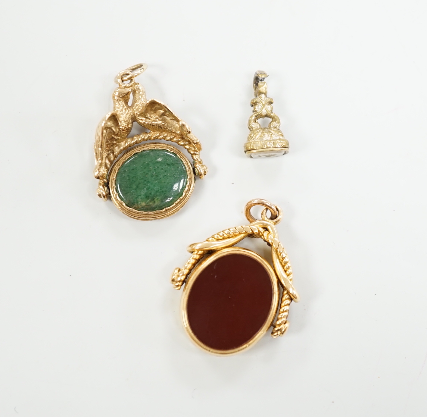 A Victorian 18ct gold and chalcedony set spinning fob, 30mm and two other fob seals including 9ct gold spinning fob.